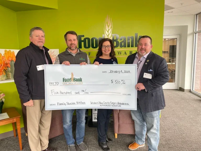 Committee members presenting a $500 cheque at the Food Bank of Delaware